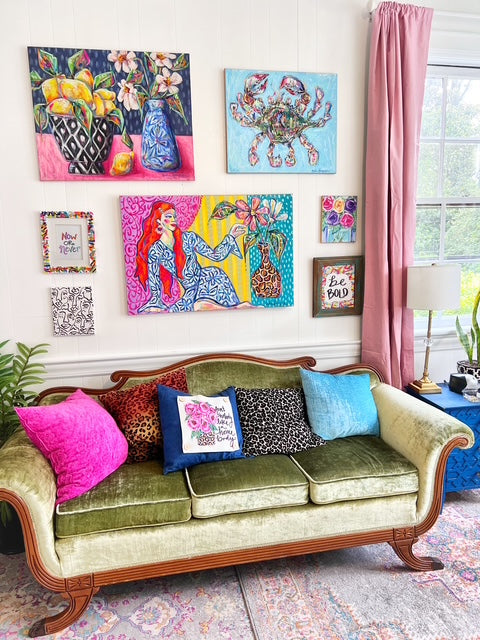 vintage sofa with whimsical art hanging over it