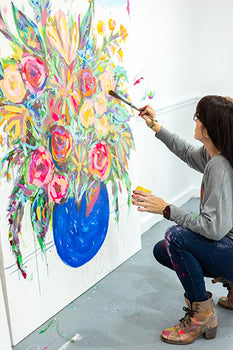 Audra painting a large canvas