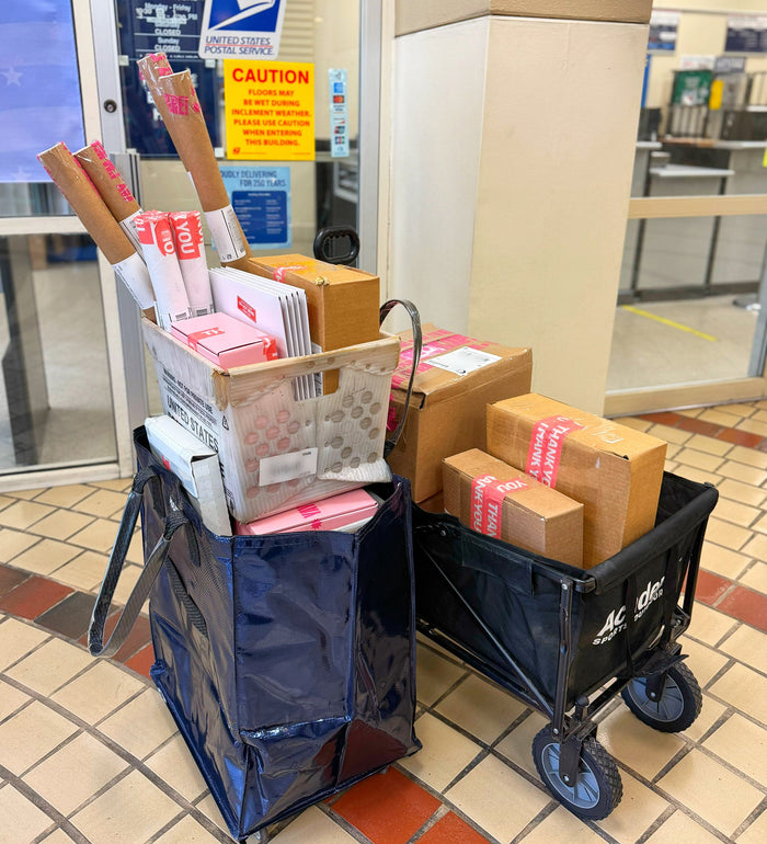 Packages in wheeled carts heading to the post office.