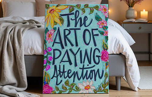 Large canvas with typography in bedroom with The Art Of Paying Attention